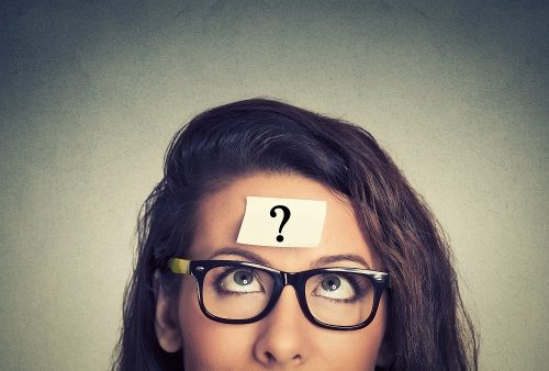 thinking woman with question mark thinking woman with question mark on gray wall background